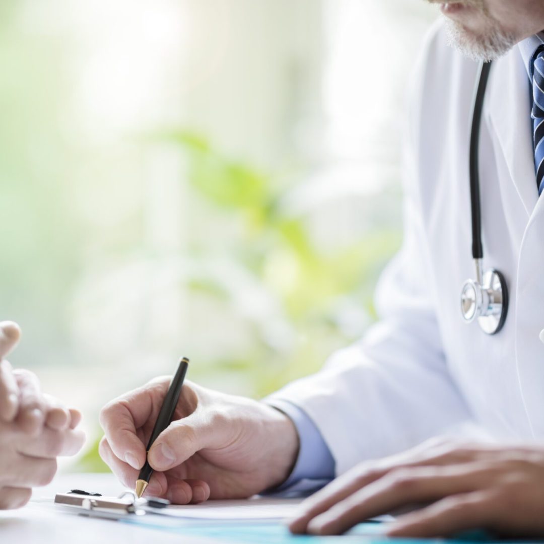 Doctor and patient taking notes in medical surgery